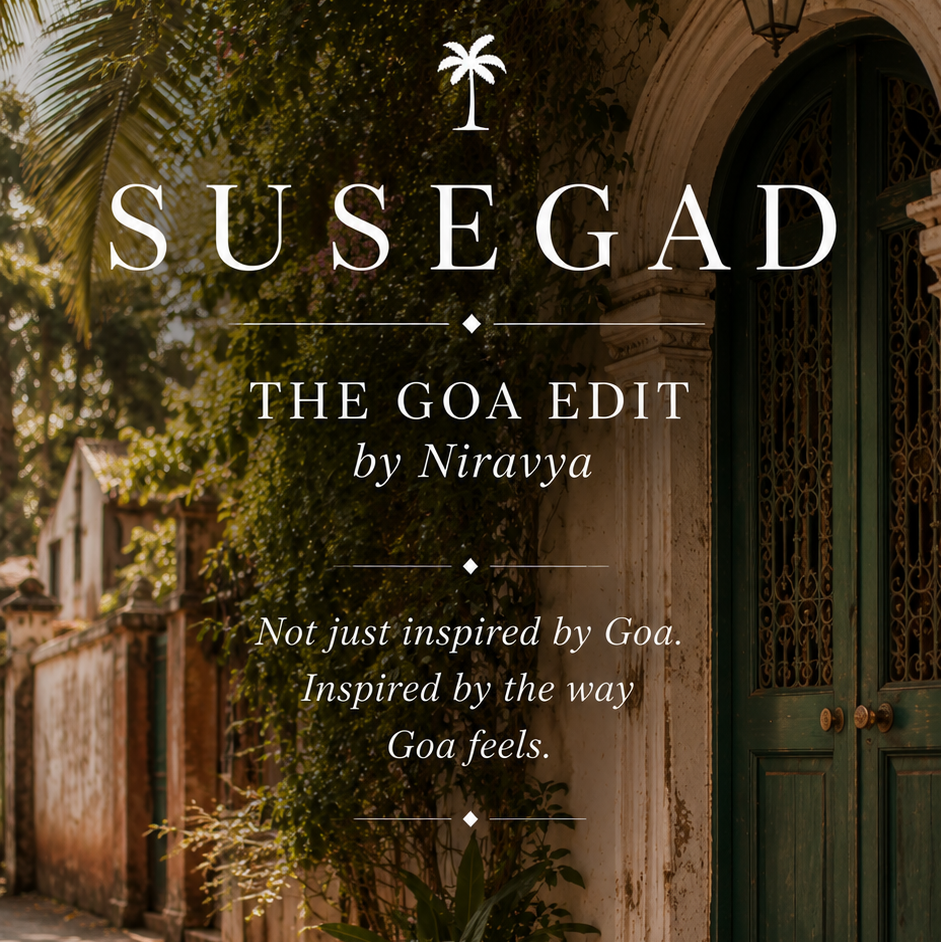 A book or album cover design featuring the title 'SUSEGAD' and subtitle 'THE GOA EDIT by Niravyya' over a photograph of a sunlit Goa street with greenery, a weathered wall, and a teal door.